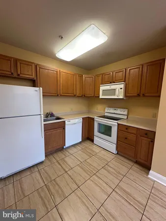 a kitchen with stainless steel appliances a stove a sink and a refrigerator