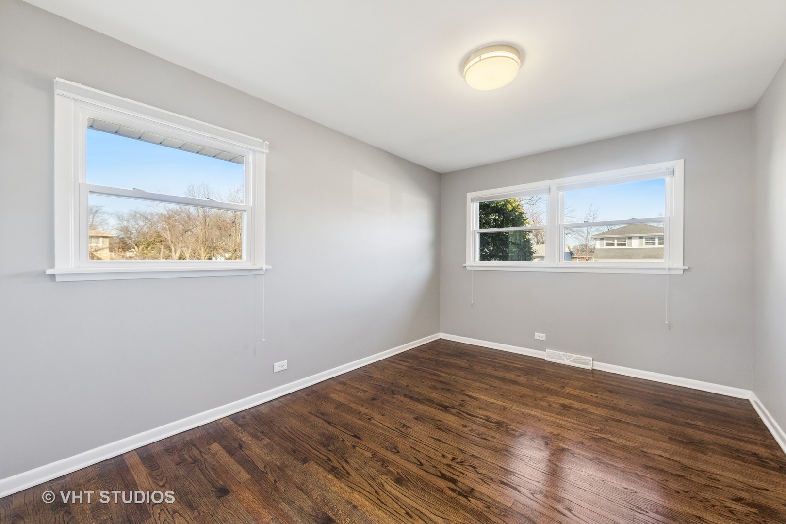 275 East Harrison Road Lombard, IL 60148 - Photo 11 of 31 a view of an empty room with wooden floor and a window