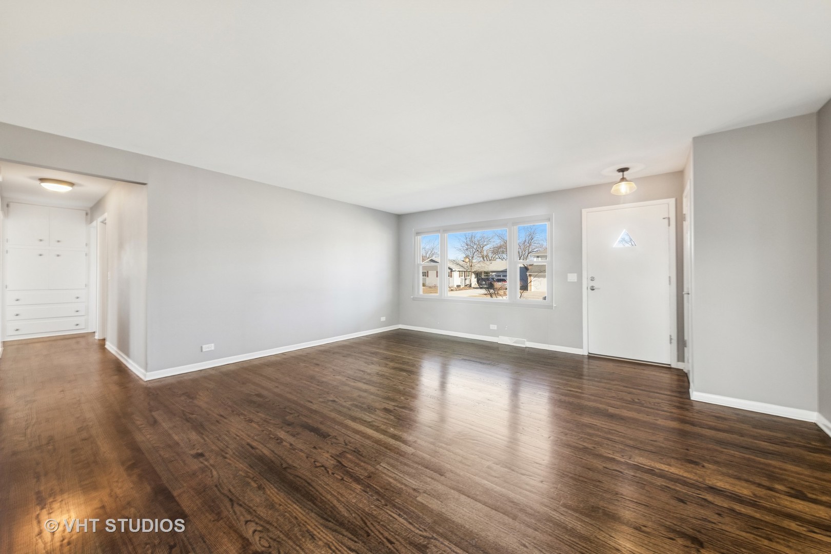 275 East Harrison Road Lombard, IL 60148 - Photo 3 of 31 a view of an empty room with wooden floor and a window