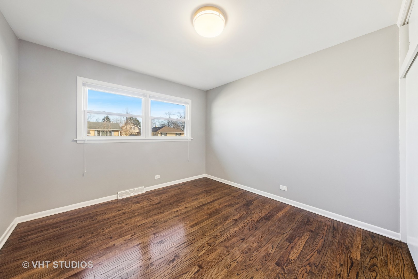 275 East Harrison Road Lombard, IL 60148 - Photo 8 of 31 an empty room with wooden floor and windows