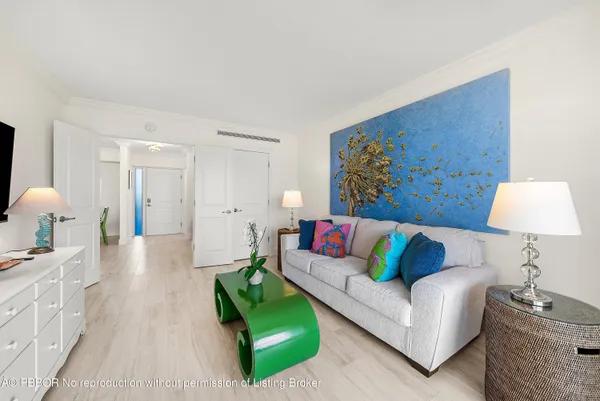 a living room with furniture and a lamp