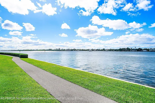 a view of a lake with houses in the back
