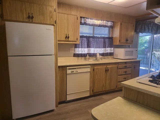 a white refrigerator freezer sitting inside of a kitchen