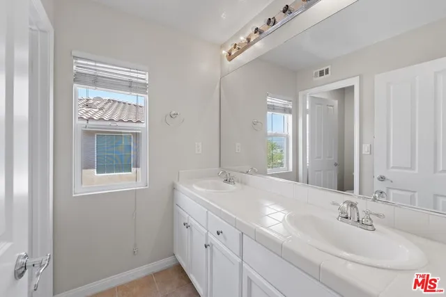 a bathroom with a sink double vanity and a mirror