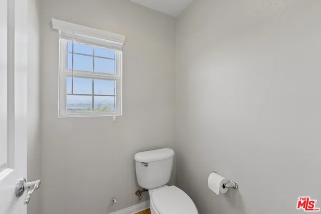 a white toilet sitting next to a bathroom sink