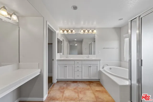a bathroom with a tub sink and mirror