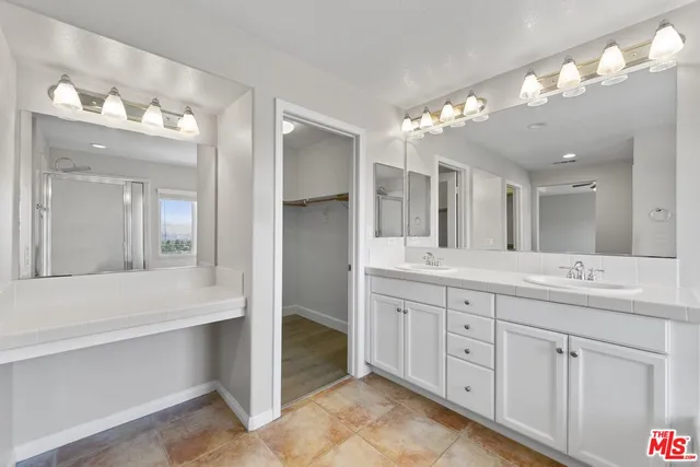 a bathroom with a double vanity sink and a mirror