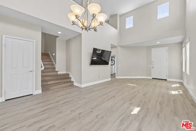 a view of a livingroom with wooden floor and a ceiling fan