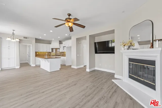 a view of a kitchen with a microwave and a fireplace