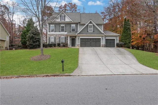 a front view of a house with a yard and garage