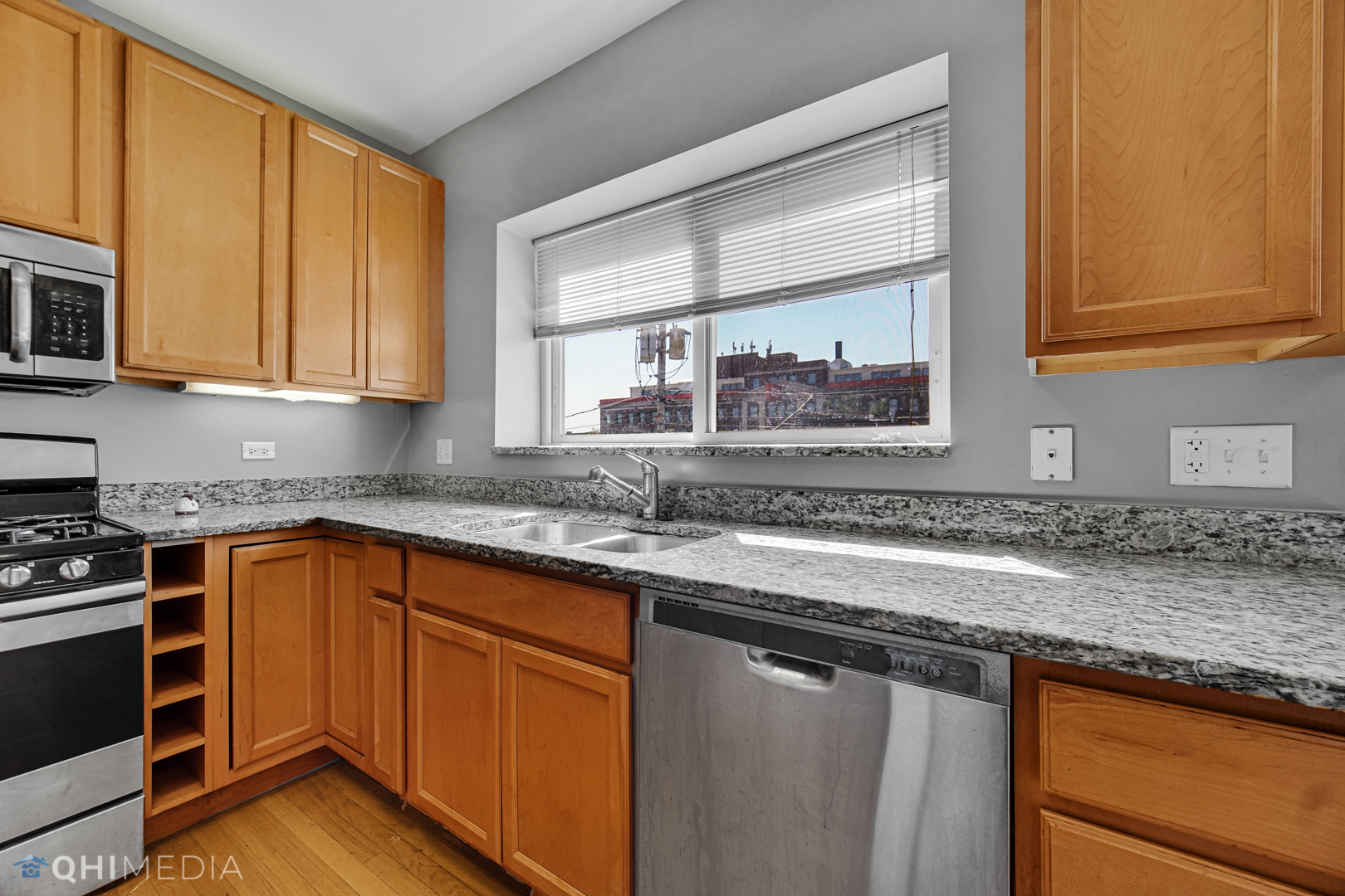 820 Dobson Street, Unit 2E Evanston, IL 60202 - Photo 11 of 19 a kitchen with stainless steel appliances granite countertop a sink stove and cabinets