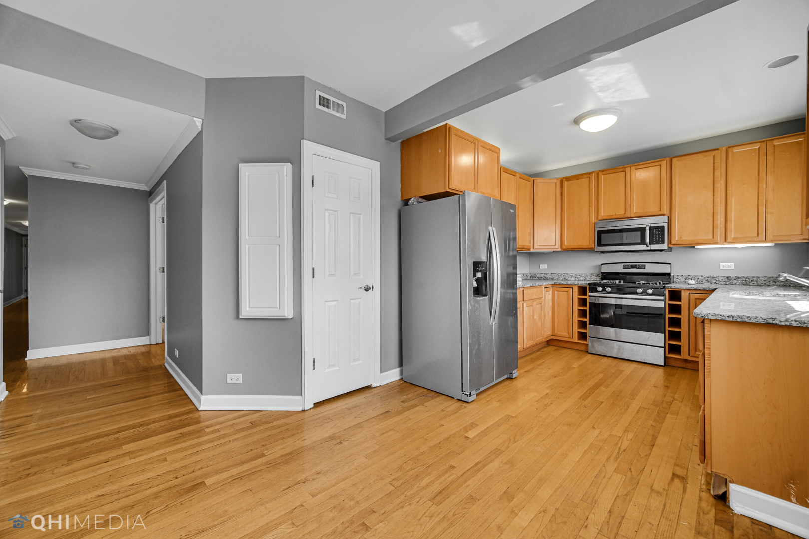 820 Dobson Street, Unit 2E Evanston, IL 60202 - Photo 12 of 19 a kitchen with stainless steel appliances granite countertop a refrigerator a stove top oven a sink and dishwasher