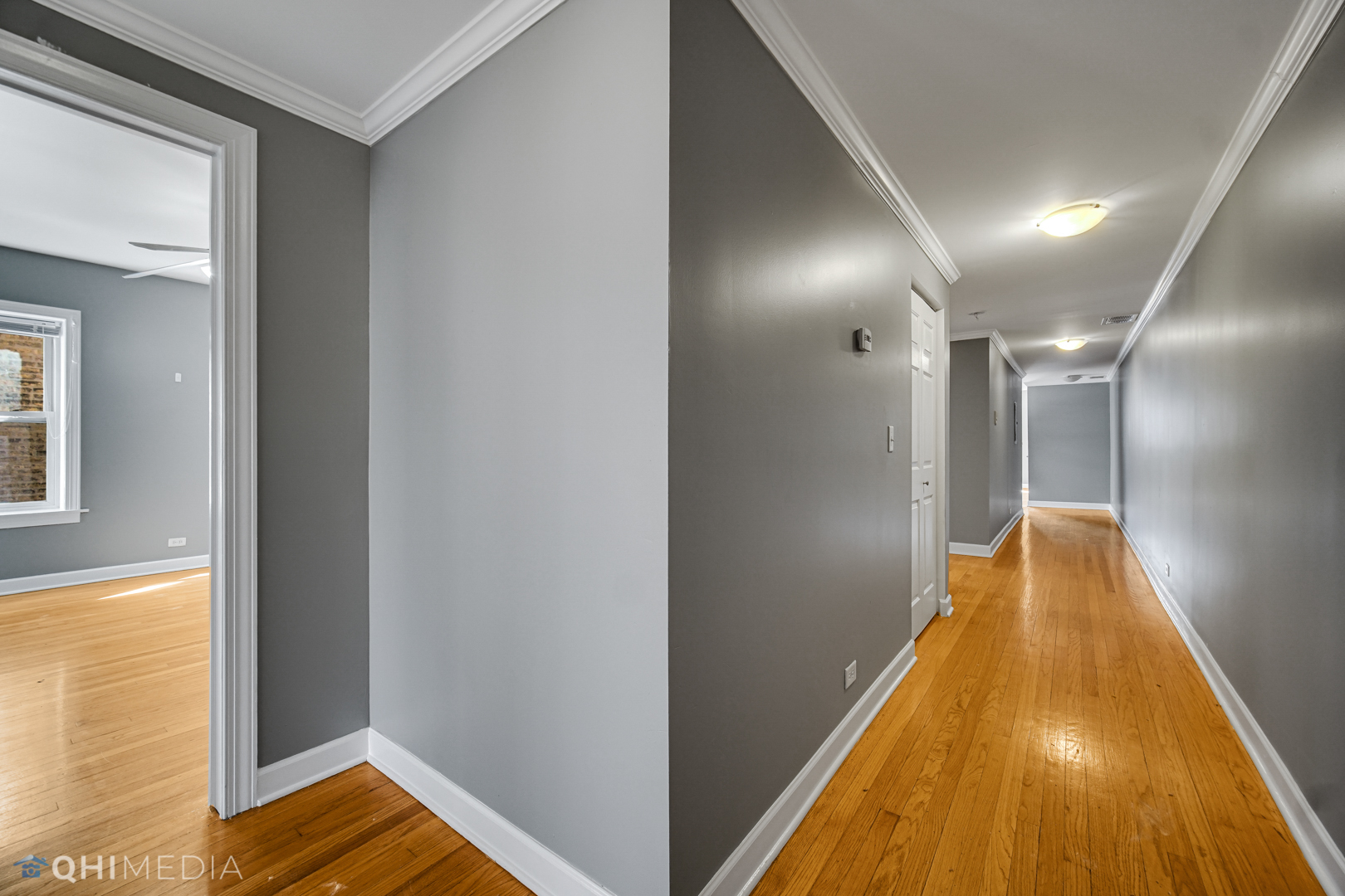 820 Dobson Street, Unit 2E Evanston, IL 60202 - Photo 14 of 19 a view of a hallway with wooden floor