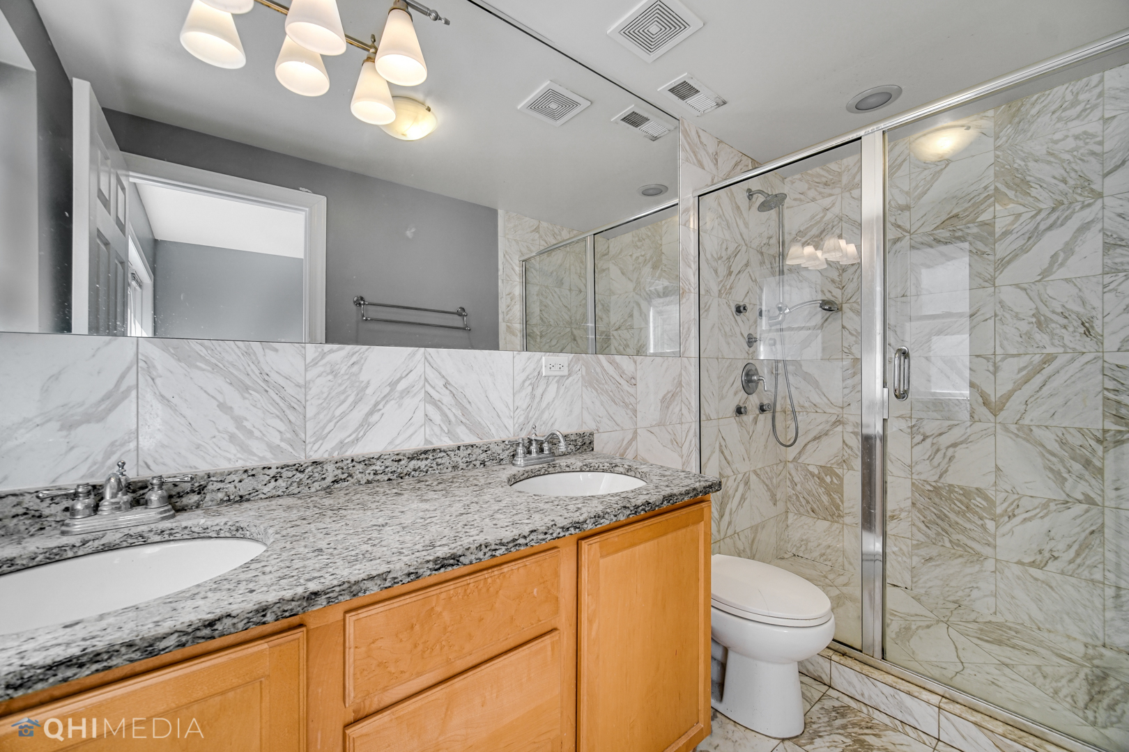 820 Dobson Street, Unit 2E Evanston, IL 60202 - Photo 15 of 19 a bathroom with a granite countertop sink toilet and shower