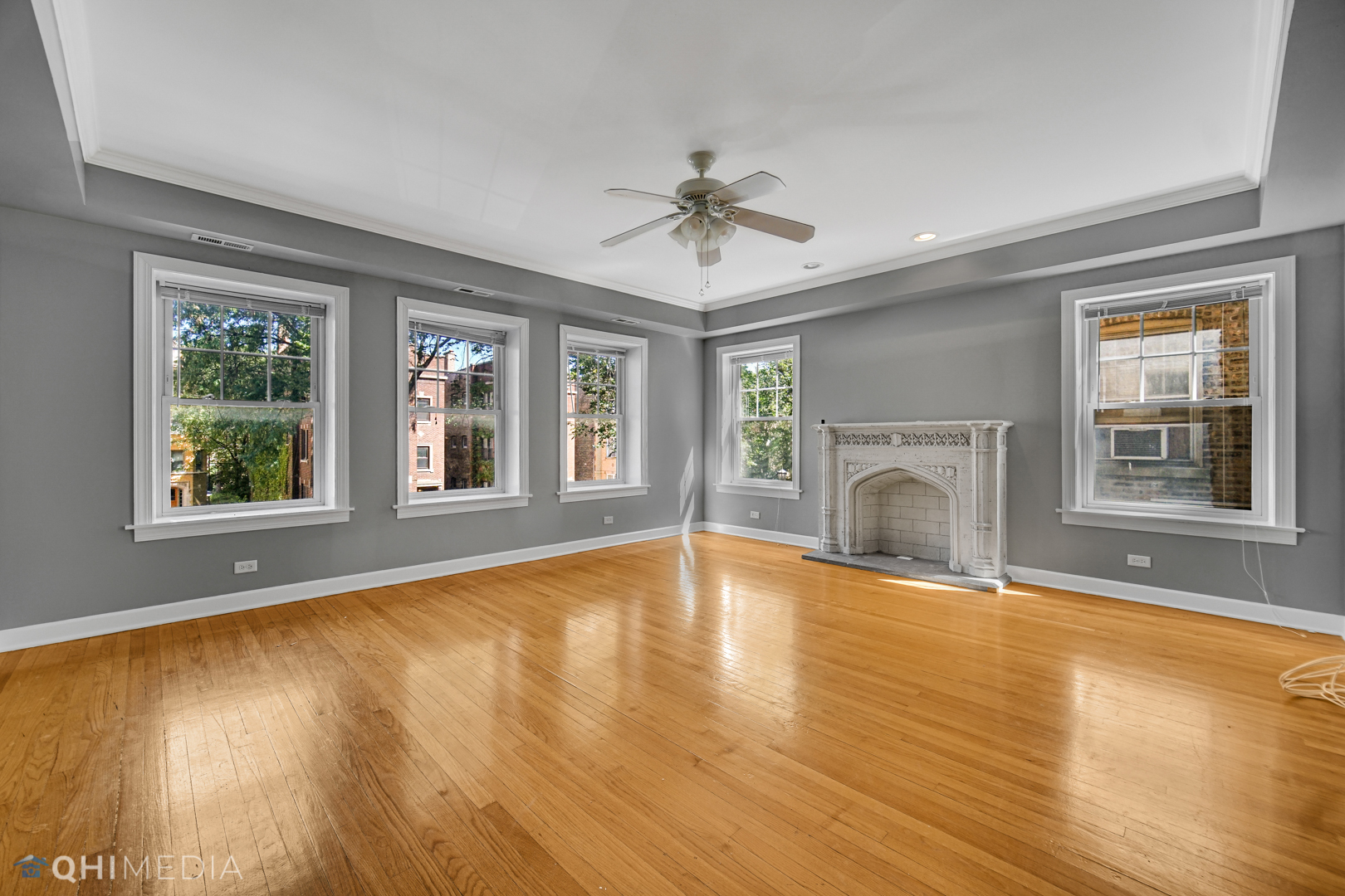 820 Dobson Street, Unit 2E Evanston, IL 60202 - Photo 5 of 19 a view of empty room with wooden floor and fireplace