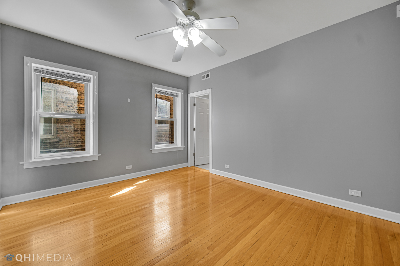 820 Dobson Street, Unit 2E Evanston, IL 60202 - Photo 7 of 19 a view of an empty room with window and chandelier fan