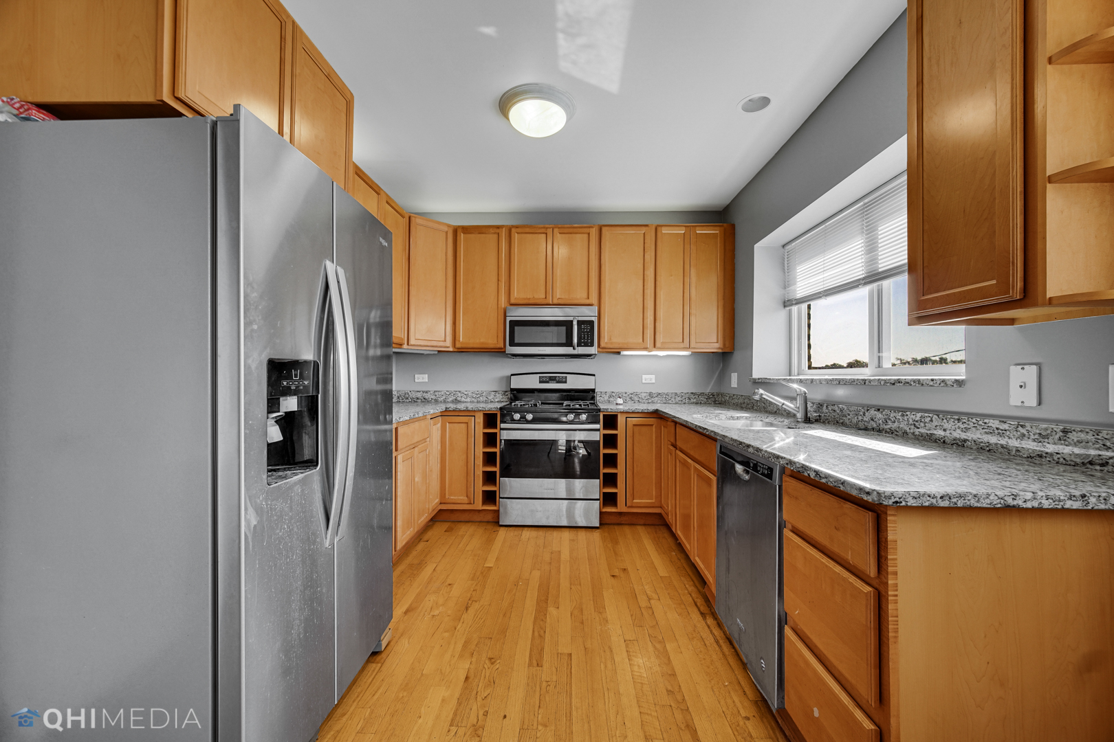 820 Dobson Street, Unit 2E Evanston, IL 60202 - Photo 9 of 19 a kitchen with stainless steel appliances granite countertop refrigerator a stove top oven a sink and dishwasher