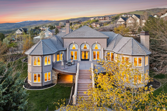 1714 Ridge Point Drive Bountiful, UT 84010 - Photo 1 of 132 Multi-level residence featuring a gray exterior, prominent turrets, a spacious outdoor deck, and extensive exterior lighting