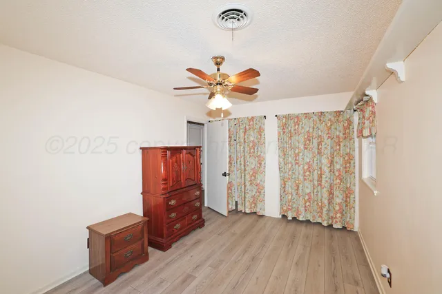 a view of room with window and ceiling fan