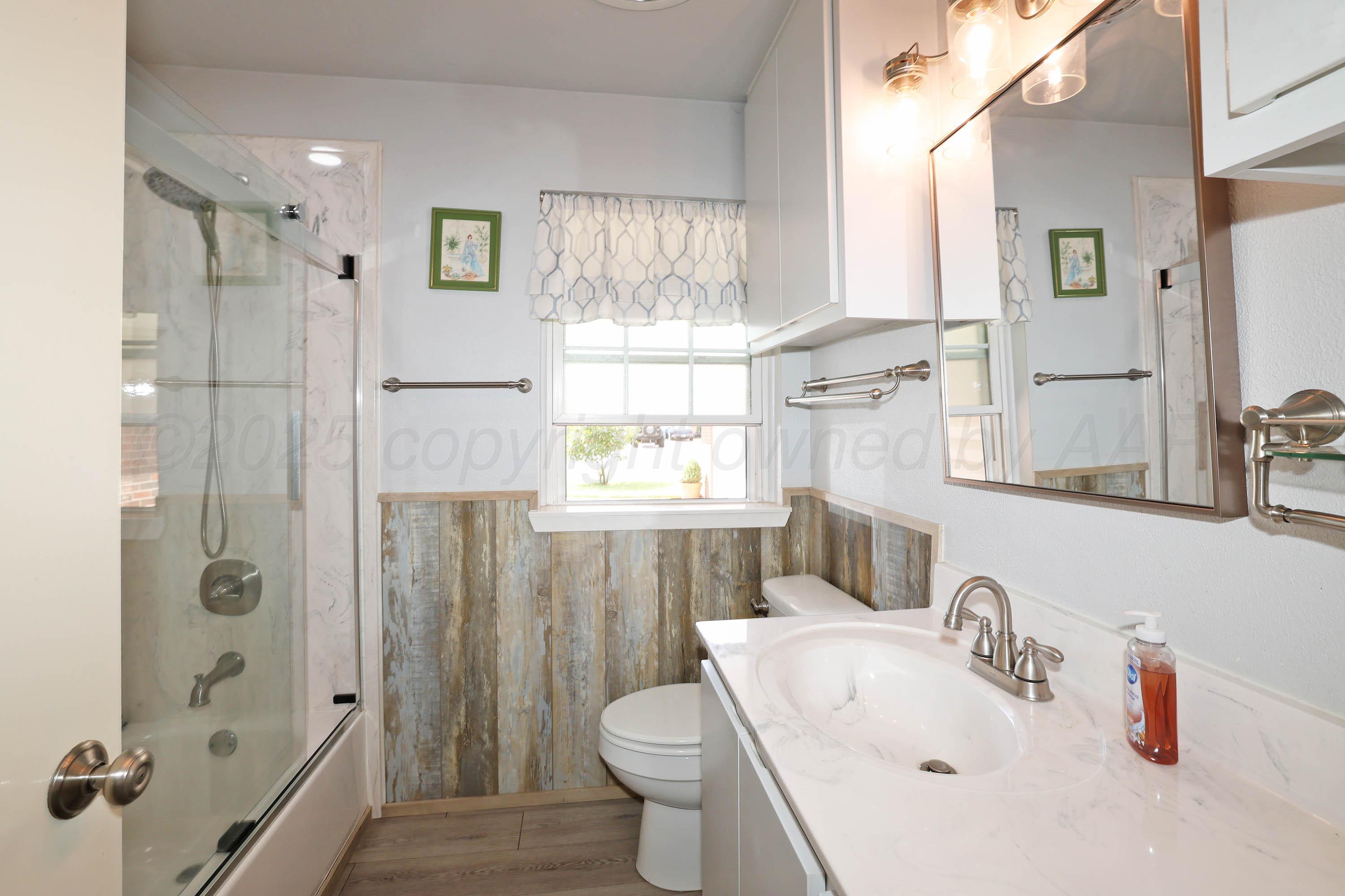 4119 Tucson Drive Amarillo, TX 79109 - Photo 17 of 22 a bathroom with a sink toilet and shower
