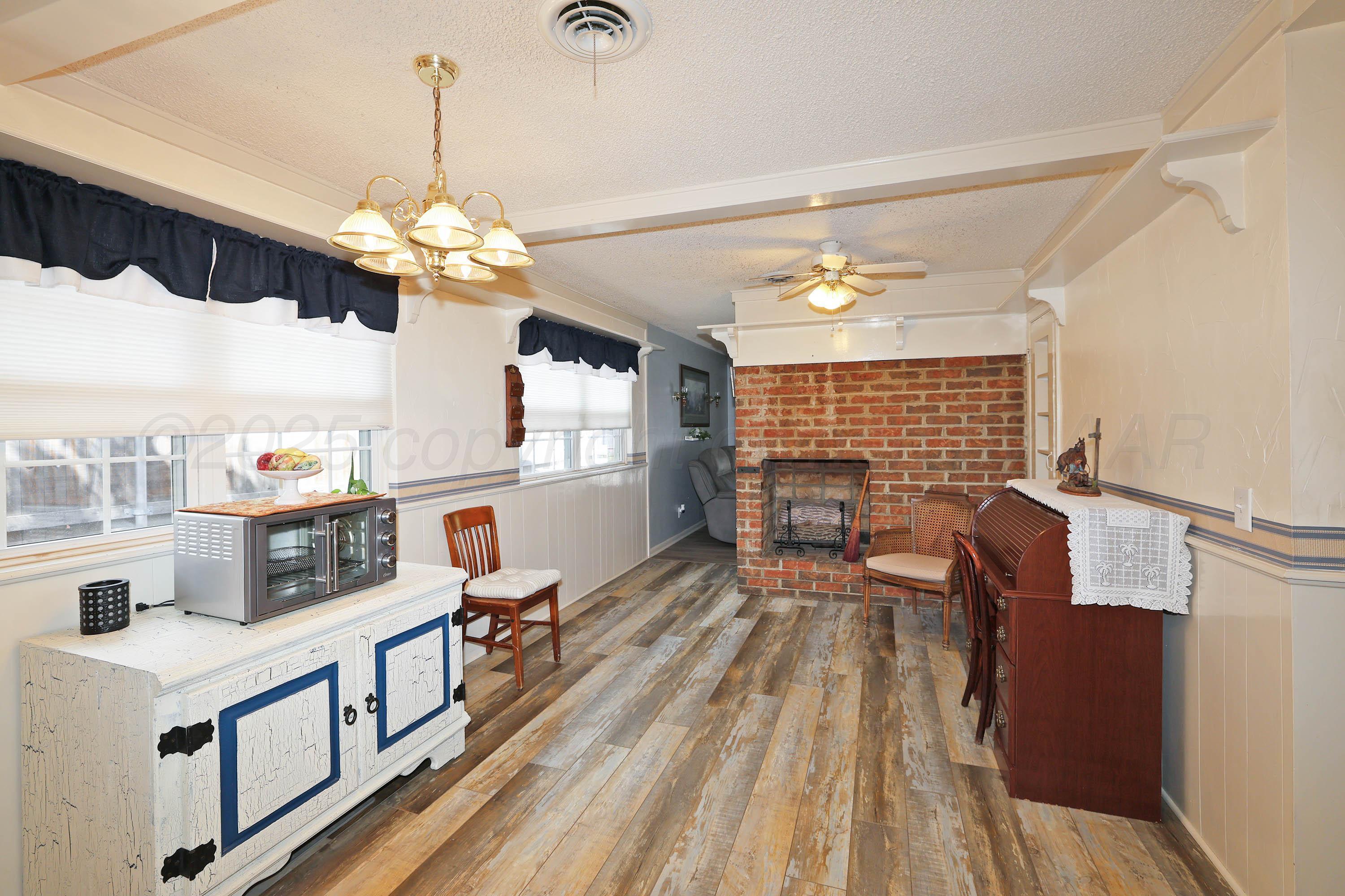 4119 Tucson Drive Amarillo, TX 79109 - Photo 6 of 22 a view of a dining room with furniture window and wooden floor