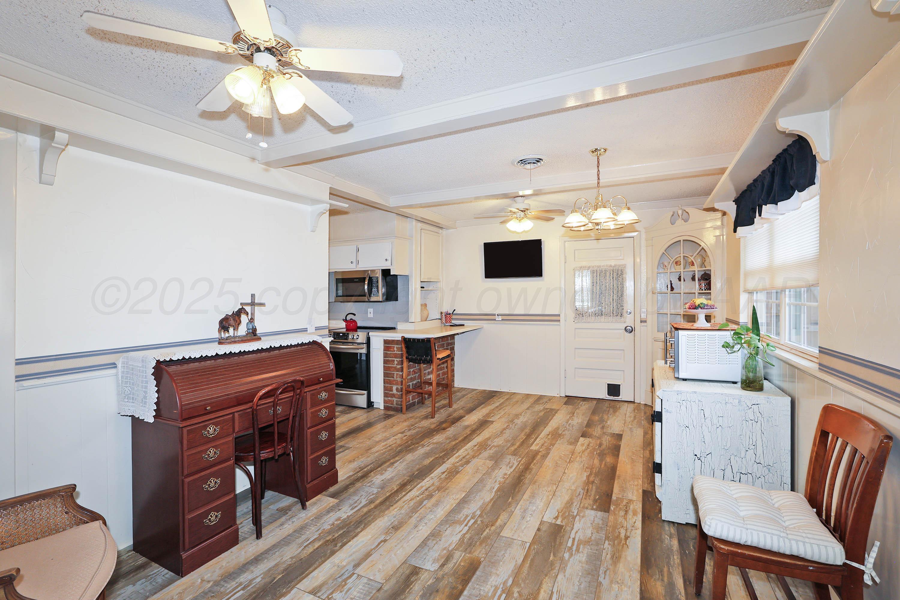 4119 Tucson Drive Amarillo, TX 79109 - Photo 7 of 22 a living room with furniture and a flat screen tv