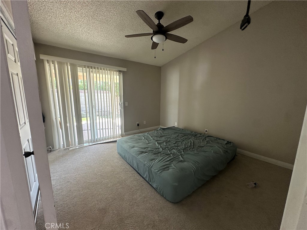 595 Cherry Vista Drive Perris, CA 92571 - Photo 6 of 20 a bedroom with a bed and a ceiling fan