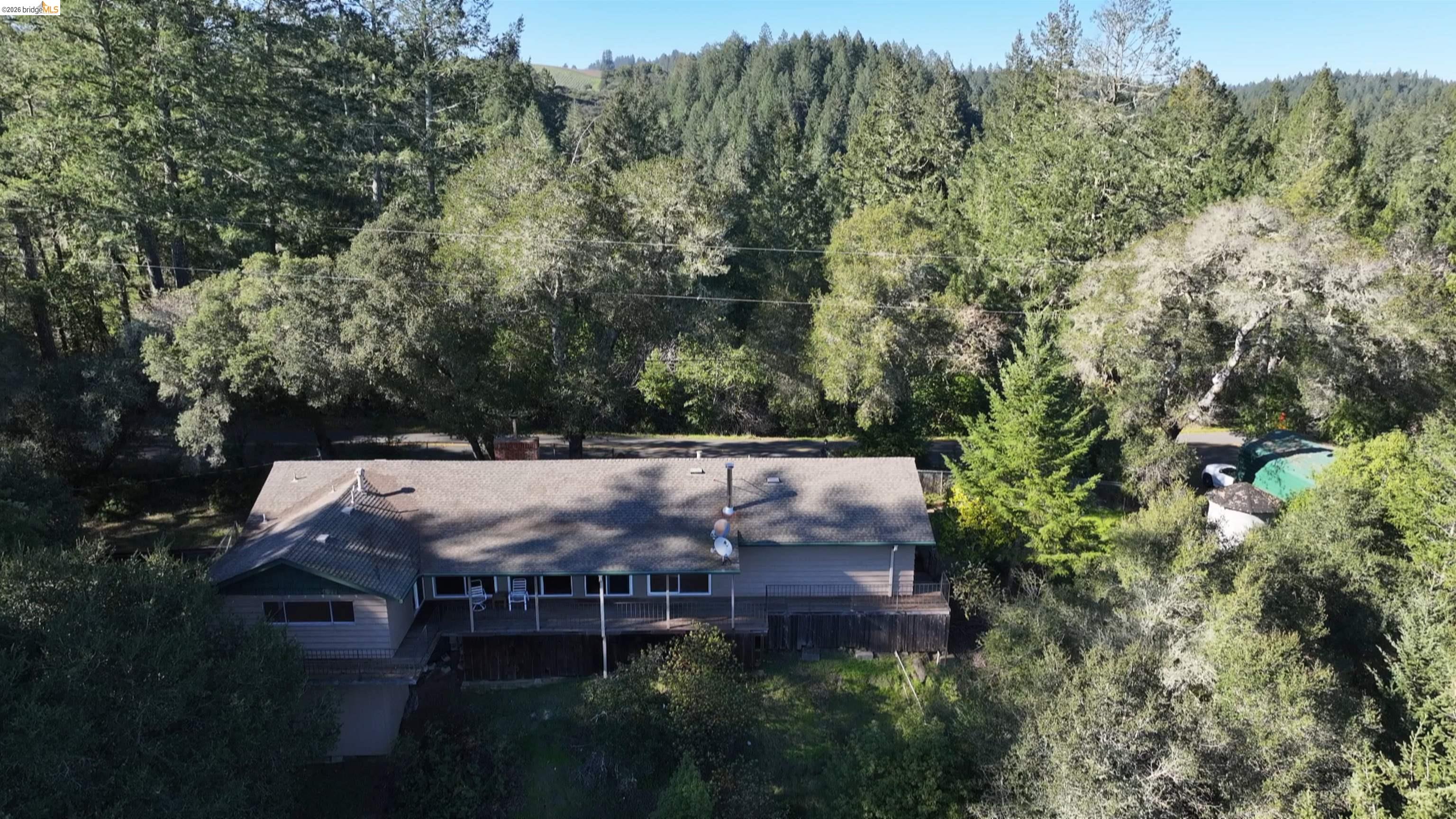 5051 Harrison Grade Road Sebastopol, CA 95472 - Photo 2 of 31 a view of house with mountain view and trees around