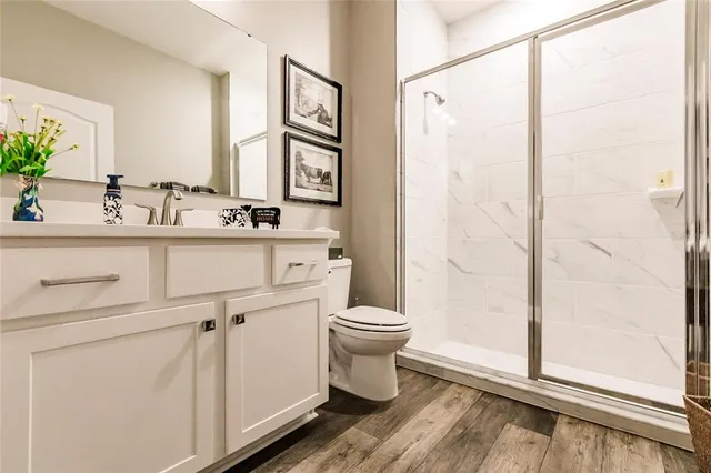 an aerial view of residential houses with outdoor space and trees