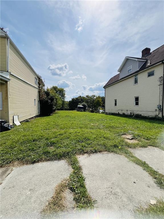 650 Addison Street Washington, PA 15301 - Photo 3 of 4 a white house with a big yard and a large parking space