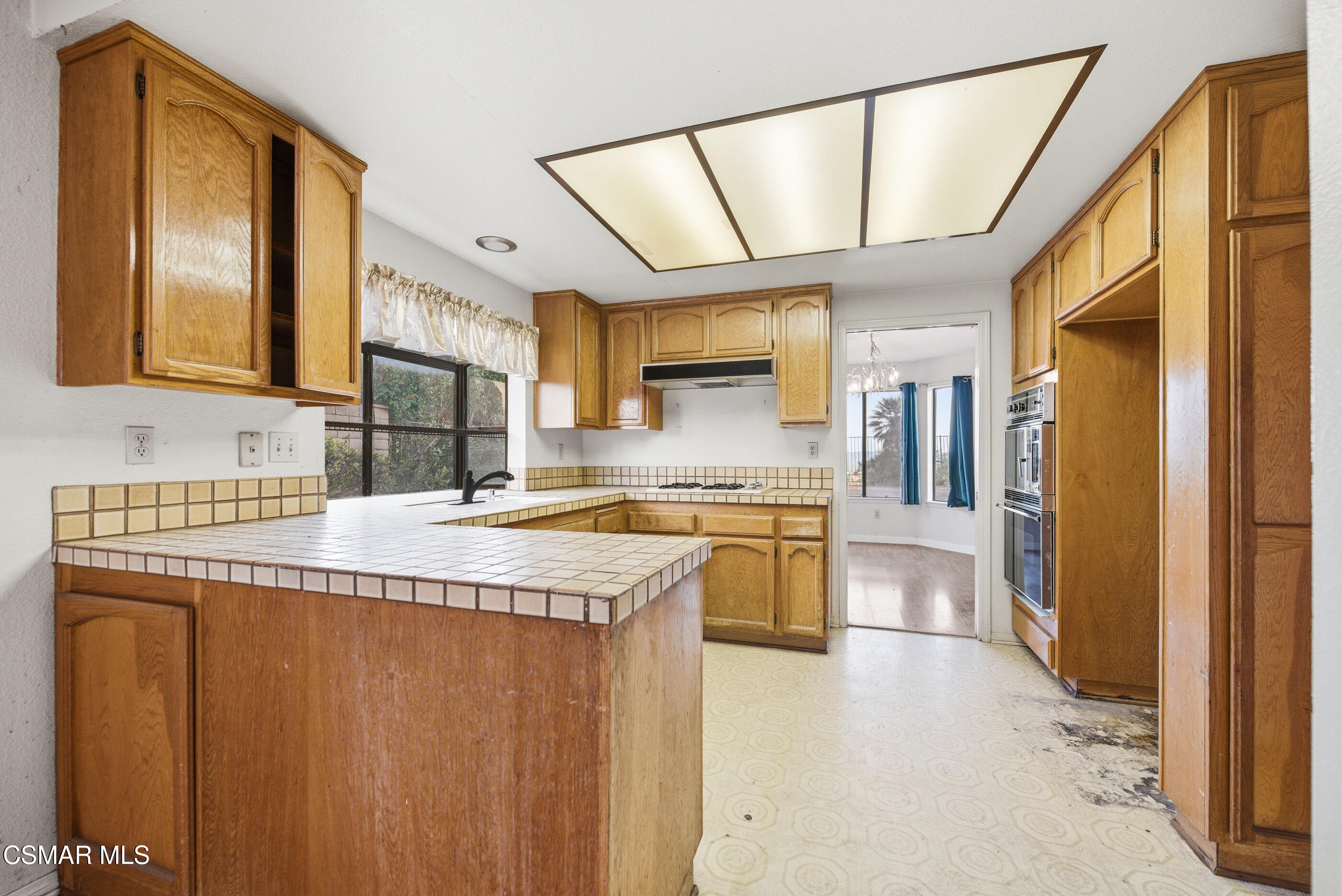 12036 Shadow Ridge Way Porter Ranch, CA 91326 - Photo 19 of 35 a kitchen with stainless steel appliances granite countertop a sink a stove and a refrigerator