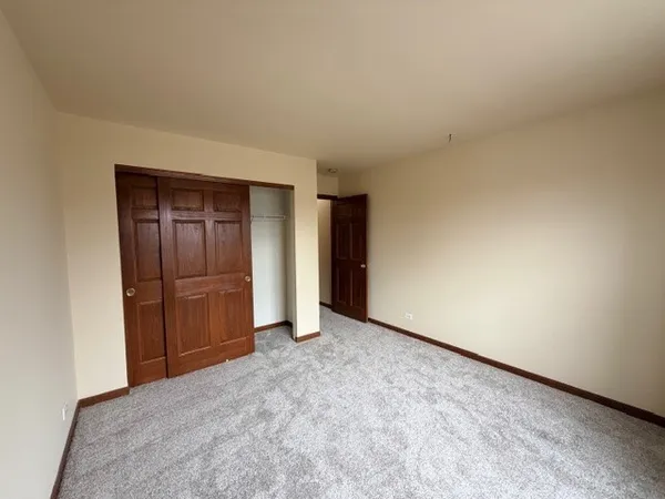 a view of an empty room and closet area