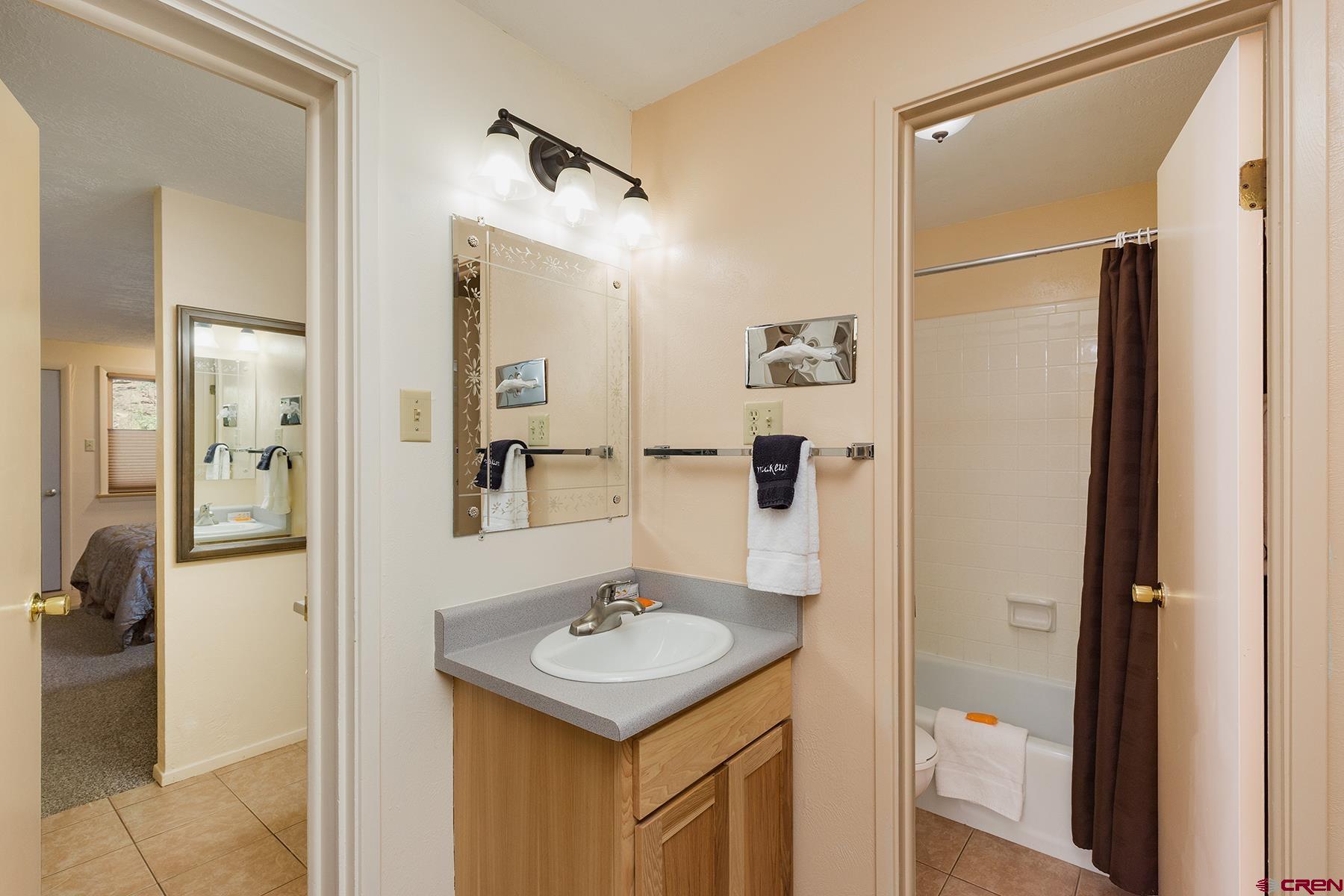 400 Sheol Street, Unit 8 Durango, CO 81301 - Photo 14 of 35 a bathroom with a sink a mirror and shower