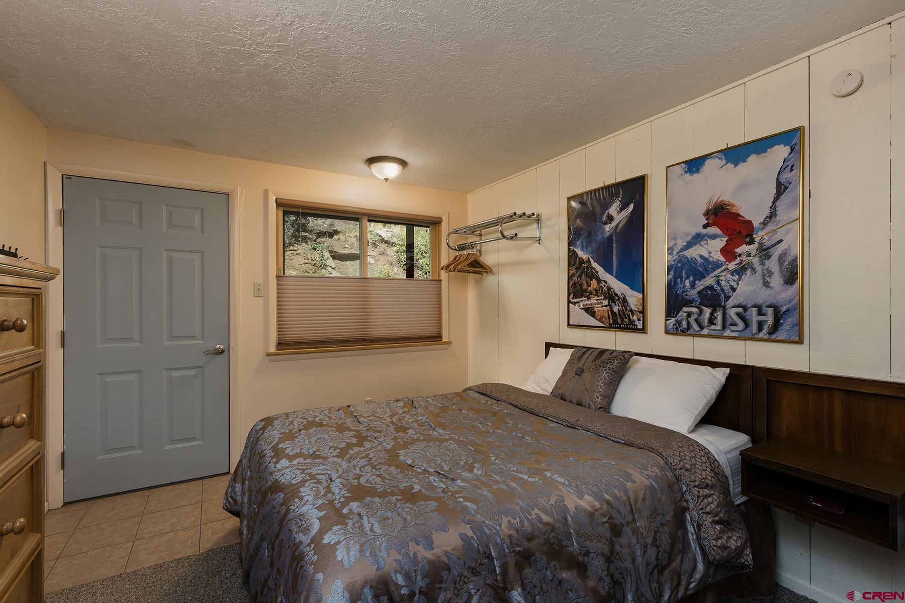 400 Sheol Street, Unit 8 Durango, CO 81301 - Photo 17 of 35 a bedroom with a bed and painting on the wall