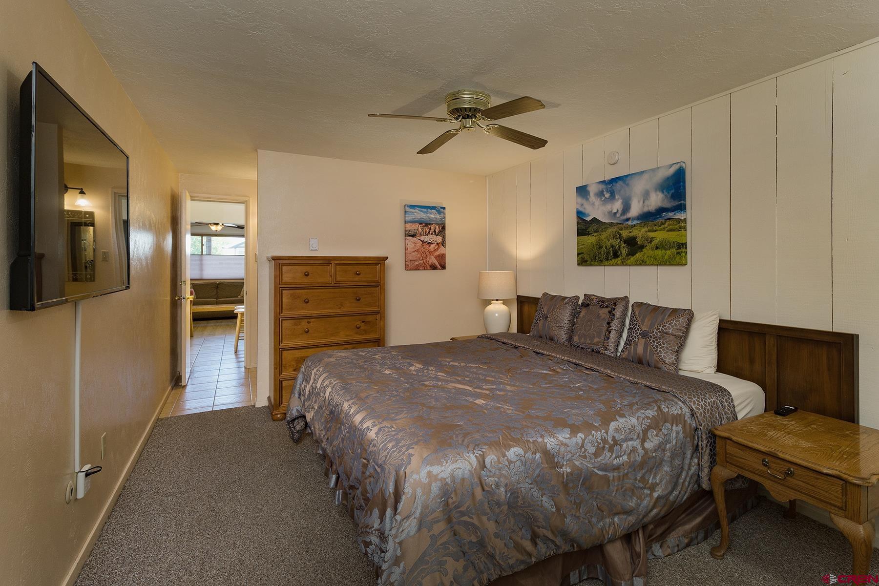 400 Sheol Street, Unit 8 Durango, CO 81301 - Photo 19 of 35 a bedroom with a bed and a chandelier