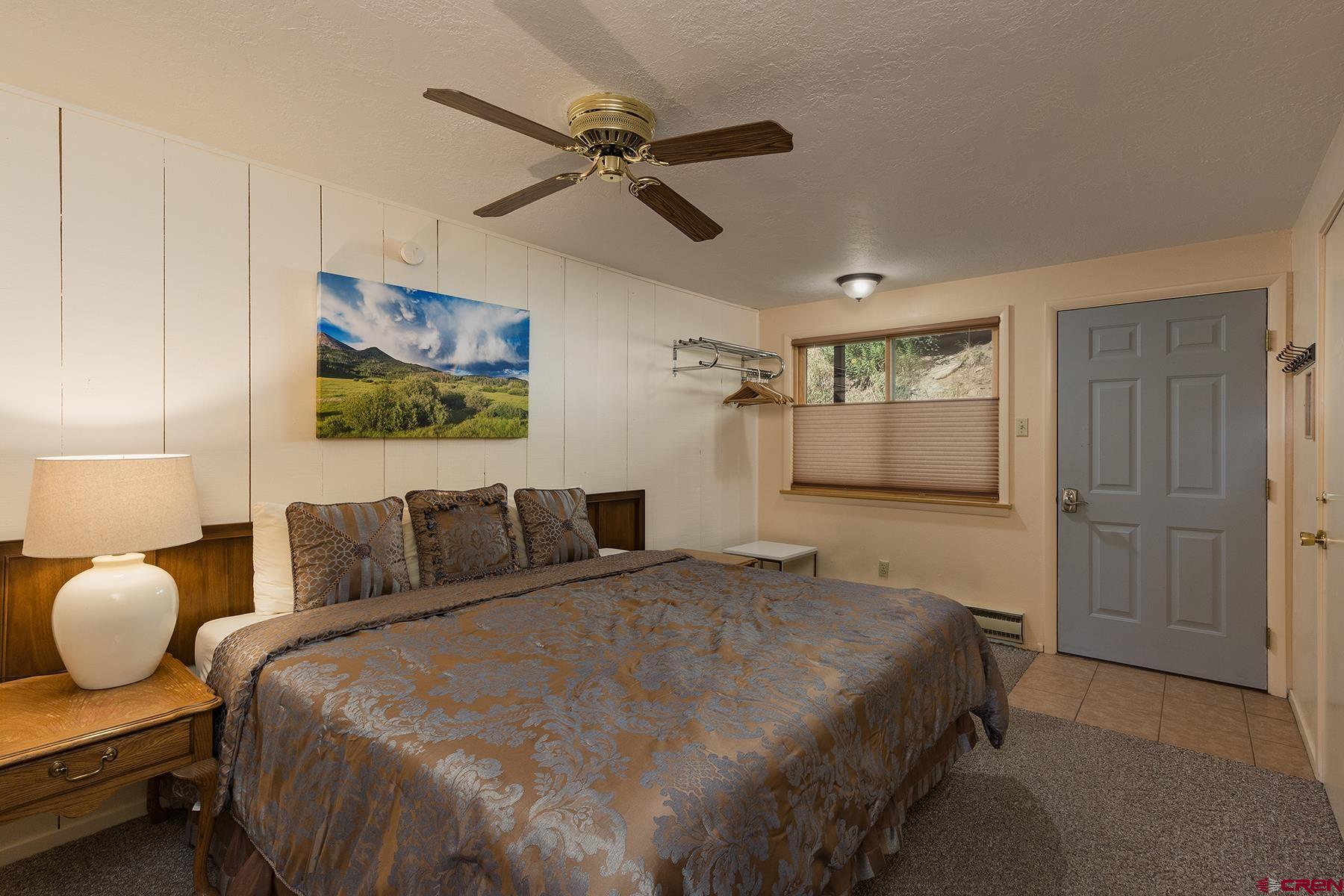 400 Sheol Street, Unit 8 Durango, CO 81301 - Photo 20 of 35 a bedroom with a bed and wooden floor