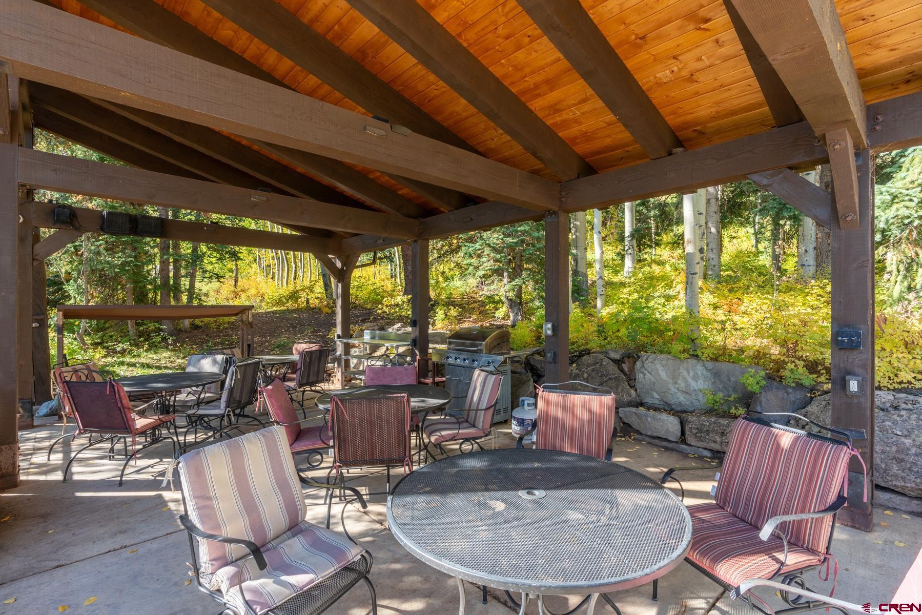 400 Sheol Street, Unit 8 Durango, CO 81301 - Photo 24 of 35 a dining room with furniture water view and a backyard