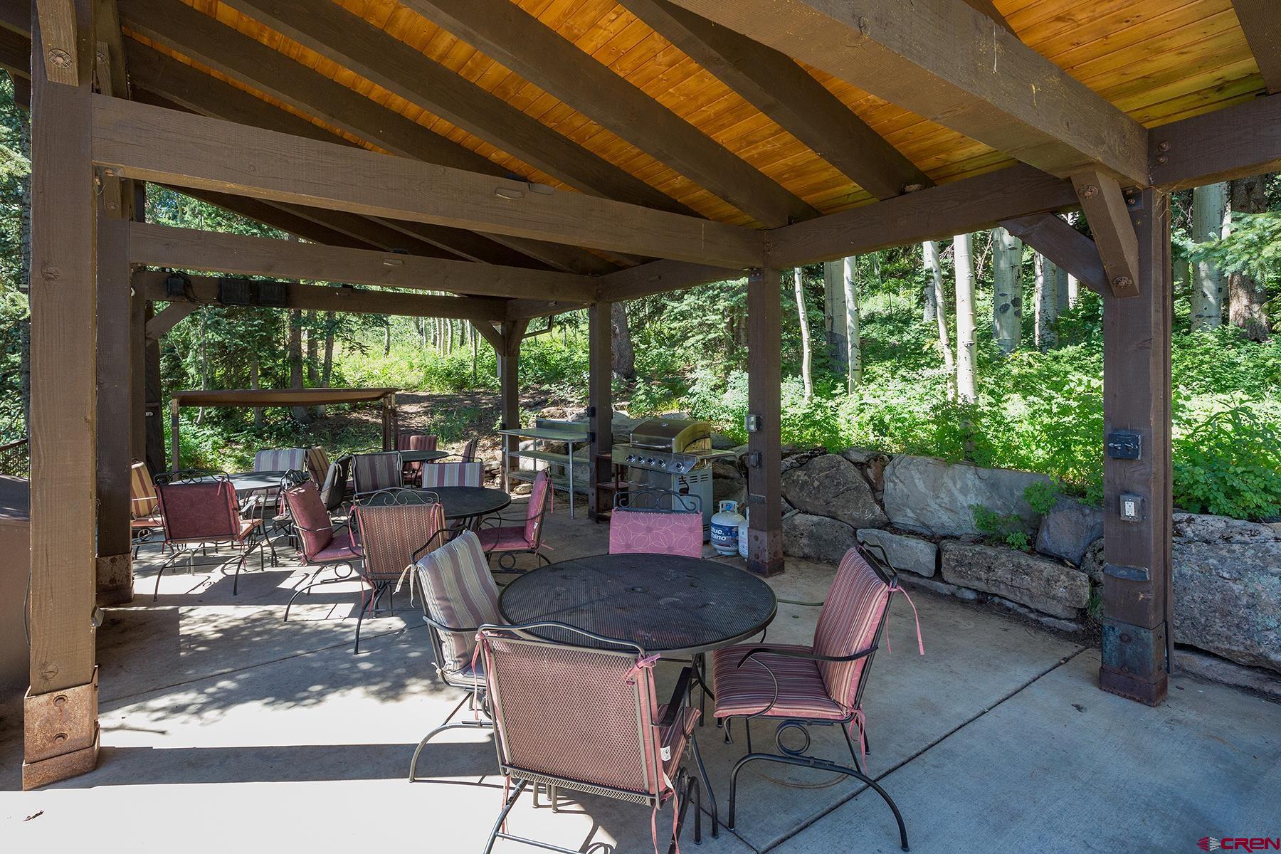 400 Sheol Street, Unit 8 Durango, CO 81301 - Photo 26 of 35 a view of a patio with table and chairs potted plants with floor to ceiling window