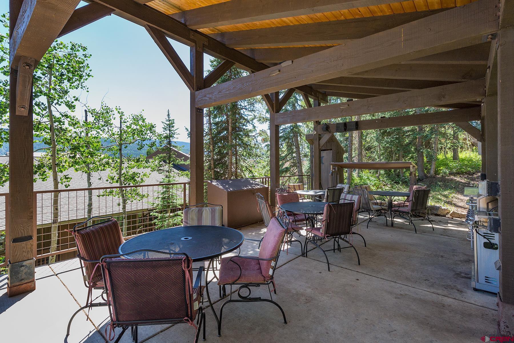 400 Sheol Street, Unit 8 Durango, CO 81301 - Photo 27 of 35 a view of a patio with table and chairs and floor to ceiling window