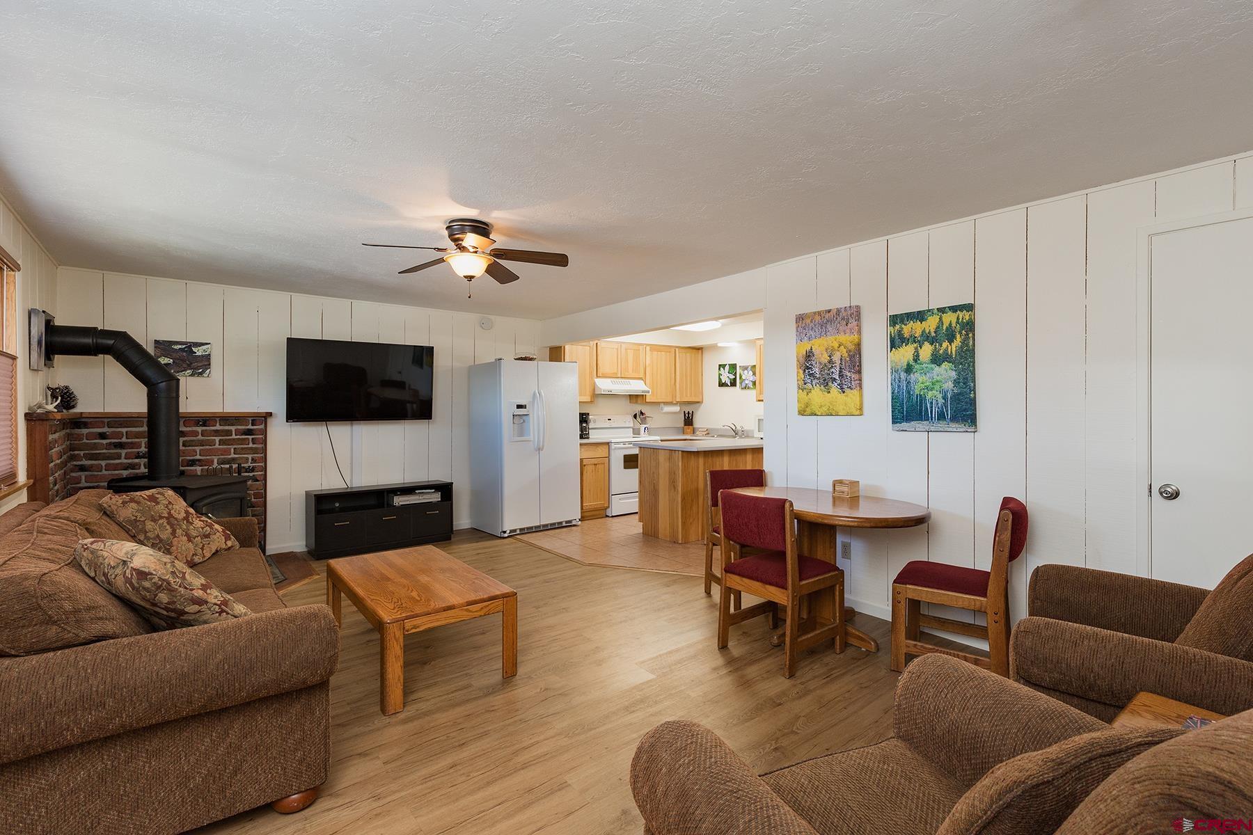 400 Sheol Street, Unit 8 Durango, CO 81301 - Photo 5 of 35 a living room with furniture kitchen view and a flat screen tv
