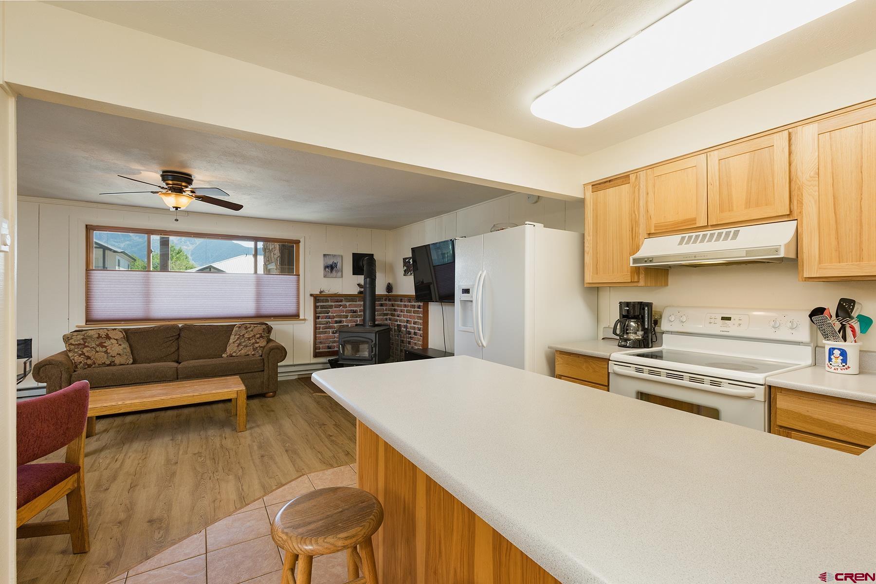 400 Sheol Street, Unit 8 Durango, CO 81301 - Photo 8 of 35 a living room with stainless steel appliances furniture a rug and a kitchen view