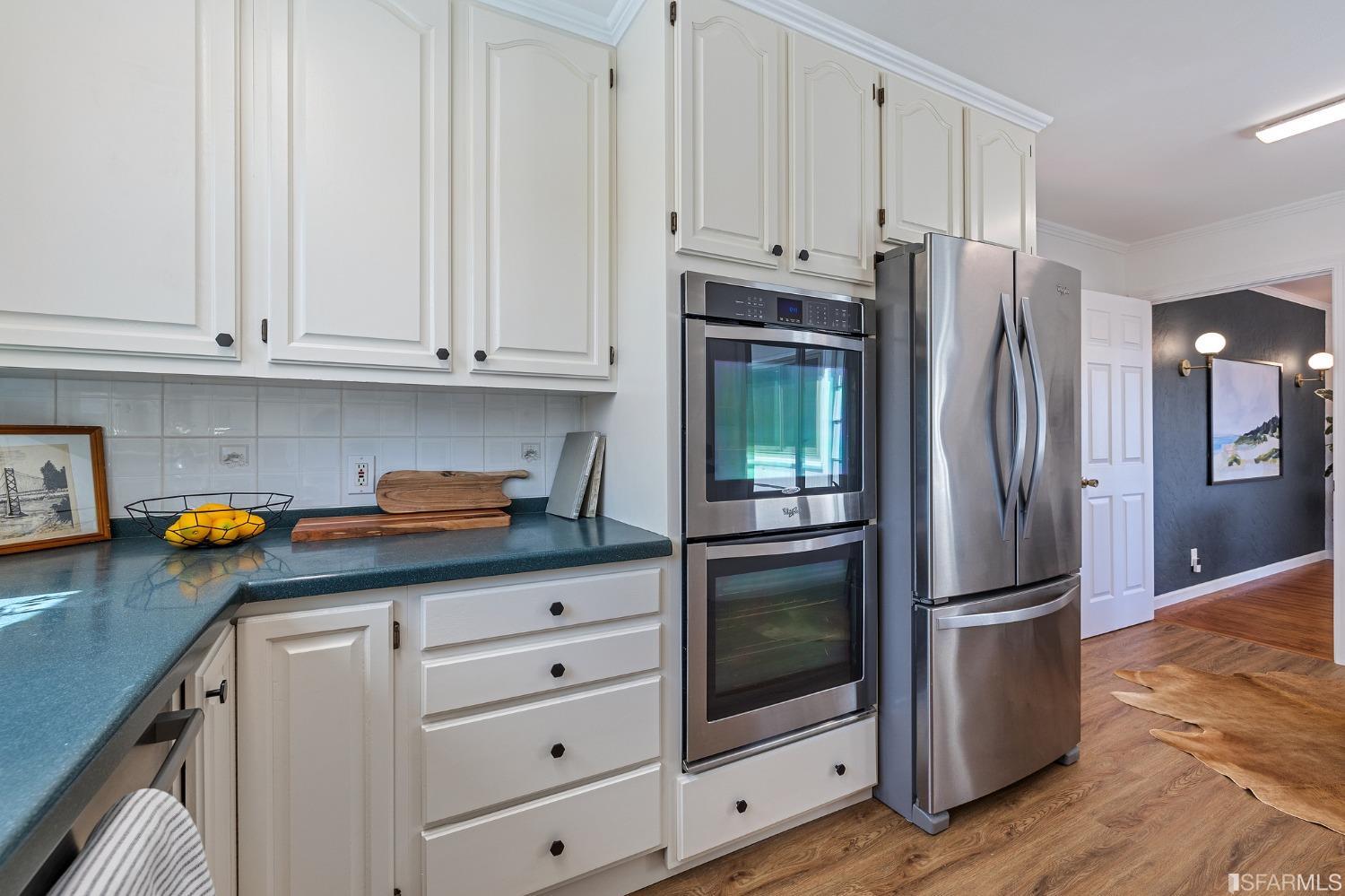 1368 Hillcrest Boulevard Millbrae, CA 94030 - Photo 25 of 65 a kitchen with stainless steel appliances granite countertop a refrigerator sink and cabinets