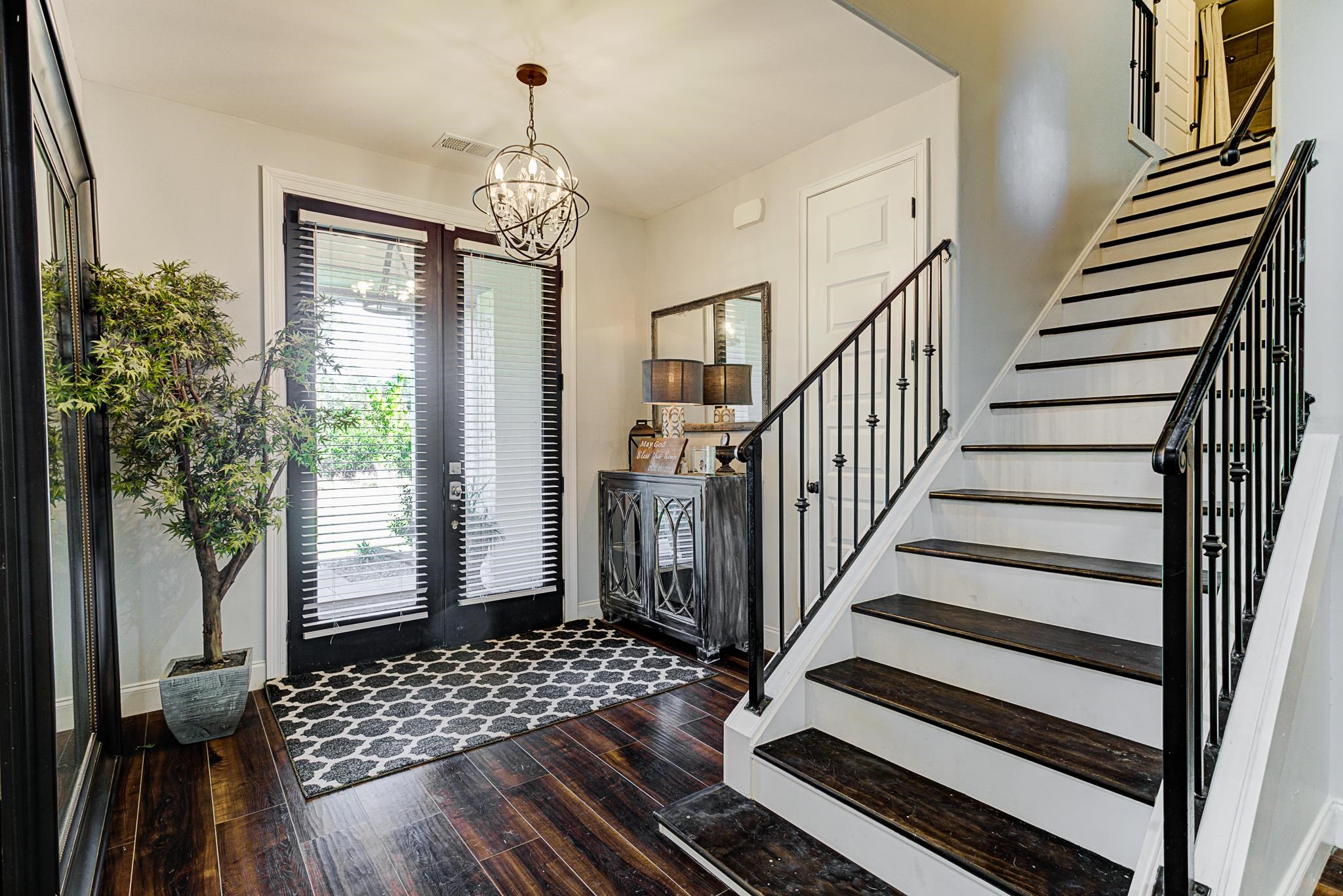 370 Wright Road Piperton, TN 38017 - Photo 4 of 31 Entrance foyer featuring dark wood-type flooring, an inviting chandelier, and french doors