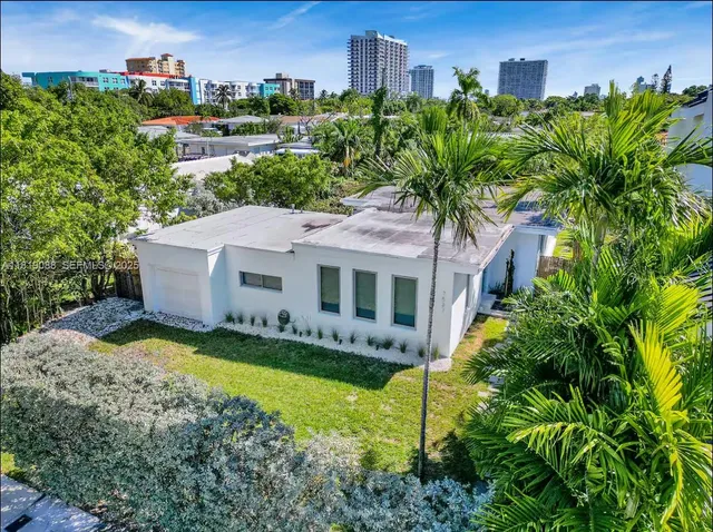 a aerial view of a house with garden and trees