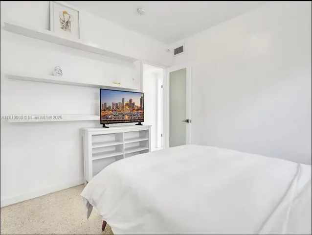 a large white bed in a white room