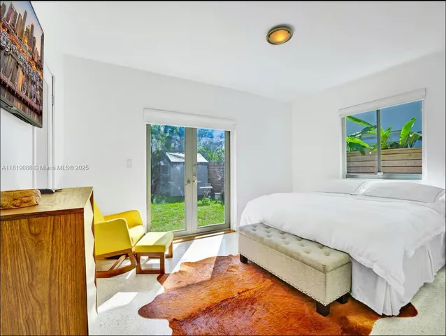 a bed sitting in a bedroom next to a window