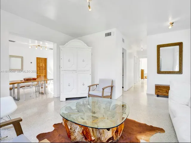 a living room with furniture and a dining table