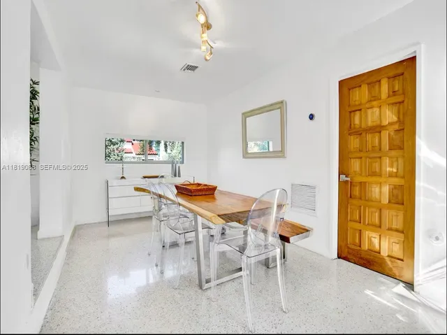 a work room with furniture and wooden floor
