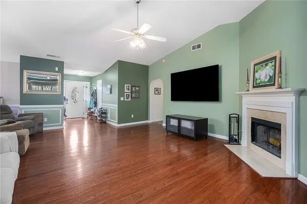 a living room with furniture fireplace and flat screen tv