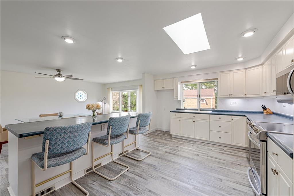9746 McClellan Street North Huntingdon, PA 15642 - Photo 12 of 30 a kitchen with granite countertop lots of counter top space and dining table